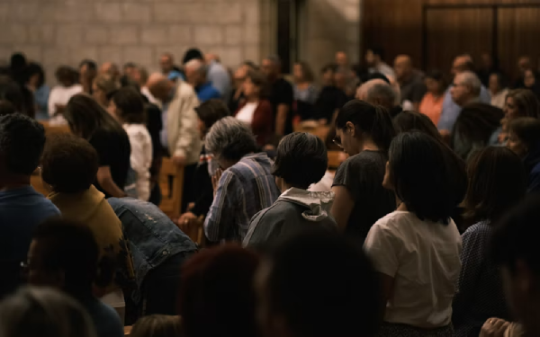 Crowd of people gathered closely together indoors